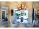 Charming breakfast nook with a glass table, cushioned seating, and a view of the outdoor patio and pool at 2962 Wilderness E Blvd, Parrish, FL 34219
