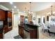 Kitchen featuring dark wood cabinets, granite countertops, stainless steel appliances, and a breakfast nook at 2962 Wilderness E Blvd, Parrish, FL 34219