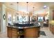Open concept kitchen with a large island, dark countertops, and seamless flow into the living areas at 2962 Wilderness E Blvd, Parrish, FL 34219