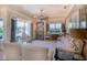 Living room featuring a fireplace, large windows with custom drapery, and plush seating arrangements at 2962 Wilderness E Blvd, Parrish, FL 34219