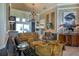 Bright living room featuring elegant seating, a chandelier, large windows, and sophisticated decor at 2962 Wilderness E Blvd, Parrish, FL 34219
