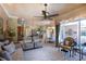 Bright living room with a ceiling fan, fireplace, and sliding glass doors leading to the outdoor seating area at 2962 Wilderness E Blvd, Parrish, FL 34219