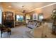 Cozy living room featuring a fireplace, plush seating, a ceiling fan, and neutral color scheme at 2962 Wilderness E Blvd, Parrish, FL 34219