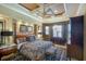 Cozy main bedroom with a decorative ceiling, king-sized bed, elegant furniture, and soft lighting at 2962 Wilderness E Blvd, Parrish, FL 34219