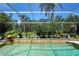 Beautiful pool featuring a decorative wall and serene green surroundings at 2962 Wilderness E Blvd, Parrish, FL 34219