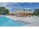 Community pool with steps, lounge chairs and tables for enjoying the outdoor space at 2962 Wilderness E Blvd, Parrish, FL 34219