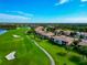 Aerial of the neighborhood with golf course and landscaping at 318 Winding Brook Ln # 104, Bradenton, FL 34212