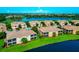Stunning aerial view of residences by a lake and golf course, offering picturesque scenery and serene surroundings at 318 Winding Brook Ln # 104, Bradenton, FL 34212