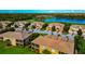 Panoramic aerial showcasing residences, lush greens, and serene ponds at 318 Winding Brook Ln # 104, Bradenton, FL 34212