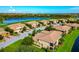 Picturesque aerial view of residences overlooking a tranquil lake and golf course with stunning blue skies at 318 Winding Brook Ln # 104, Bradenton, FL 34212