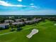 Scenic aerial view of a golf community with sand traps, tree-lined streets, and well-kept lawns at 318 Winding Brook Ln # 104, Bradenton, FL 34212
