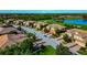 Beautiful aerial view of the neighborhood, lush green landscaping, and serene water features at 318 Winding Brook Ln # 104, Bradenton, FL 34212