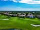 Scenic aerial view of a golf course community with well-maintained lawns and beautiful landscaping at 318 Winding Brook Ln # 104, Bradenton, FL 34212