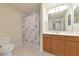 Bathroom featuring shower over bath, marine themed shower curtain, and vanity with storage at 318 Winding Brook Ln # 104, Bradenton, FL 34212