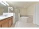 Spacious bathroom with tiled shower, soaking tub, and double vanity at 318 Winding Brook Ln # 104, Bradenton, FL 34212