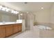Bright bathroom featuring a large soaking tub, separate shower, and double vanity with ample counter space at 318 Winding Brook Ln # 104, Bradenton, FL 34212