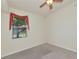 Bedroom features a window with decorative valance, neutral walls, and carpeted floor at 318 Winding Brook Ln # 104, Bradenton, FL 34212