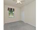 Bedroom featuring a window with decorative valance, neutral walls, closet and carpeted floor at 318 Winding Brook Ln # 104, Bradenton, FL 34212