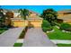 Charming townhomes with brick driveways, lush landscaping, and attached garages, offering comfortable living at 318 Winding Brook Ln # 104, Bradenton, FL 34212
