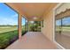Covered lanai with ceiling fan and serene golf course view at 318 Winding Brook Ln # 104, Bradenton, FL 34212
