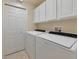 Convenient laundry room features a washer, dryer, and storage at 318 Winding Brook Ln # 104, Bradenton, FL 34212