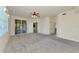 Spacious living room with plush carpeting and access to a screened lanai at 318 Winding Brook Ln # 104, Bradenton, FL 34212