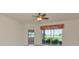 Bright living room featuring sliding glass doors overlooking a golf course and lake at 318 Winding Brook Ln # 104, Bradenton, FL 34212