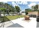 The backyard features a dining table and barbecue, perfect for outdoor entertaining at 327 Francis Dr, Apollo Beach, FL 33572