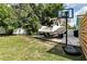 Backyard scene with boat on trailer, basketball hoop, and privacy fence at 327 Francis Dr, Apollo Beach, FL 33572