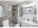 Stylish bathroom featuring a glass-enclosed shower, modern vanity, and tropical-themed wallpaper at 327 Francis Dr, Apollo Beach, FL 33572