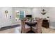 Bright dining area featuring a round table set for four, with natural light and seamless transition to the entryway at 327 Francis Dr, Apollo Beach, FL 33572