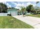 Charming single-story home with a well-maintained lawn, fenced yard, and a paved driveway leading to an attached garage at 327 Francis Dr, Apollo Beach, FL 33572