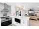 Modern kitchen with stainless appliances and an open view to the living room and access to outdoor living at 327 Francis Dr, Apollo Beach, FL 33572
