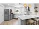 Bright kitchen with stainless steel appliances, a kitchen island with bar stool seating, and sleek white cabinetry at 327 Francis Dr, Apollo Beach, FL 33572