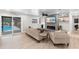 Cozy living room featuring an electric fireplace, coastal decor, and a sliding door to the outdoor pool at 327 Francis Dr, Apollo Beach, FL 33572