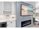 Stylish living area with a built-in fireplace, coastal decor, and a seamless view to the outdoor scenery at 327 Francis Dr, Apollo Beach, FL 33572