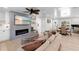 Comfortable living room with a fireplace, coastal decor, and seamless flow into the dining area, creating an inviting space at 327 Francis Dr, Apollo Beach, FL 33572