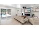 Cozy living room features a decorative fireplace, access to the outdoor living area and a coastal-themed decor at 327 Francis Dr, Apollo Beach, FL 33572