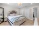 Comfortable main bedroom with a king-size bed, light-colored furniture, and access to the ensuite bathroom at 327 Francis Dr, Apollo Beach, FL 33572