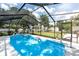 Backyard featuring a screened-in pool with a clean patio and a lush green lawn at 327 Francis Dr, Apollo Beach, FL 33572