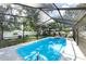 A lovely, screened-in pool featuring a bright blue, refreshing water and inviting backyard at 327 Francis Dr, Apollo Beach, FL 33572