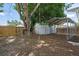 Large backyard with a shed, mature tree, and a wooden privacy fence at 3310 W 9Th Ave, Bradenton, FL 34205