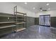 Spacious basement with exposed ceiling and shelving for storage or customization at 3310 W 9Th Ave, Bradenton, FL 34205