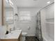 Modern bathroom with a sleek vanity, hexagon tile flooring, and tub with tile surround at 3310 W 9Th Ave, Bradenton, FL 34205