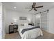 Cozy bedroom featuring a decorative ceiling fan and a sliding barn door to bathroom at 3310 W 9Th Ave, Bradenton, FL 34205