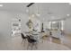Open dining space with modern lighting fixtures that flows into the living room at 3310 W 9Th Ave, Bradenton, FL 34205