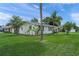 Well-kept white home with lush green lawn and mature landscaping at 3310 W 9Th Ave, Bradenton, FL 34205