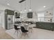 Kitchen featuring custom cabinets, stainless steel appliances, and modern lighting at 3310 W 9Th Ave, Bradenton, FL 34205
