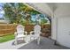 Cozy outdoor patio featuring two white Adirondack chairs, perfect for relaxing at 3310 W 9Th Ave, Bradenton, FL 34205