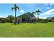 Well-manicured lawn and palm trees leading to the private pool and screened in patio at 340 Bermuda Ct # 5, Venice, FL 34293